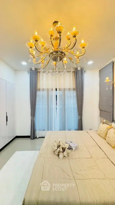 Luxurious bedroom with elegant chandelier and stylish decor