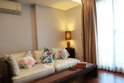 Cozy living room with elegant sofa and natural light, perfect for relaxation.