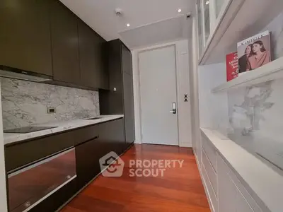 Modern kitchen with sleek cabinetry and marble backsplash