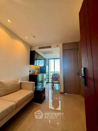 Modern living room with sleek design, featuring a cozy sofa and open kitchen layout, perfect for urban living.