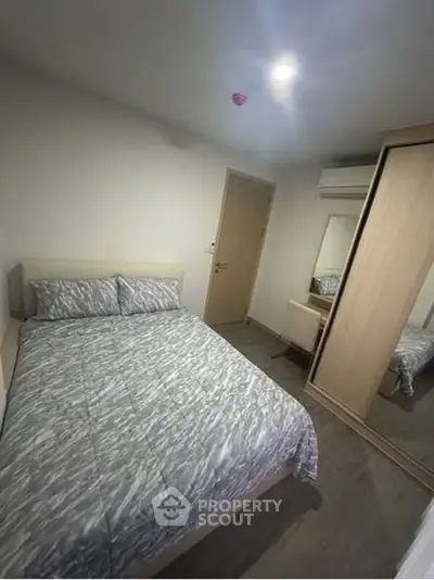 Cozy bedroom with modern decor and ample storage space