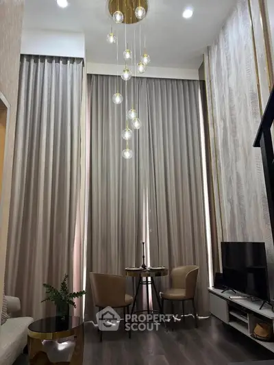 Elegant living room with high ceilings, modern lighting, and stylish decor