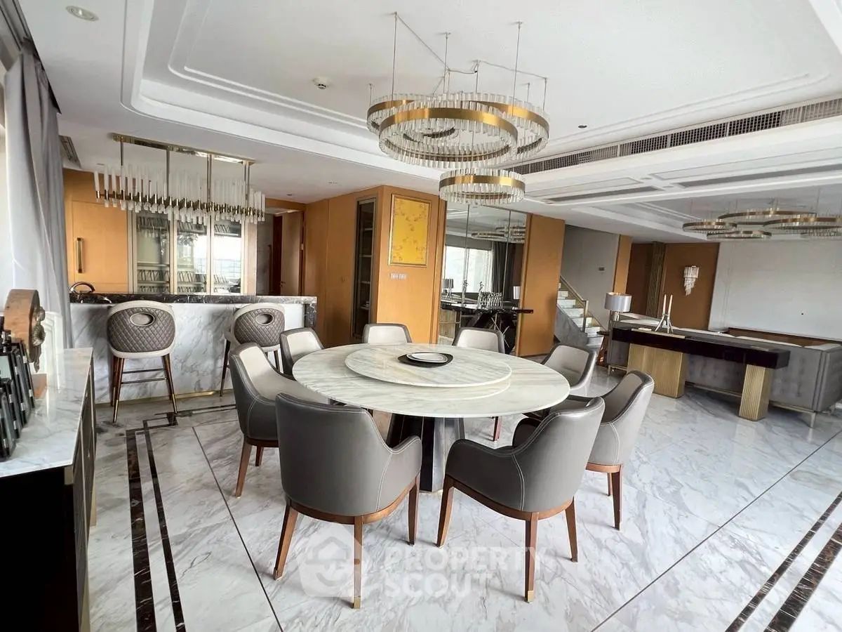 Luxurious dining area with elegant marble flooring and modern chandelier
