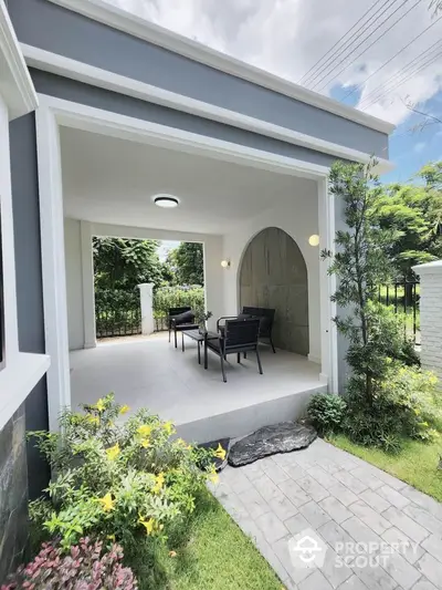 Charming outdoor patio with modern seating and lush garden view