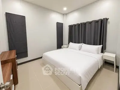 Spacious modern bedroom with elegant decor and cozy ambiance