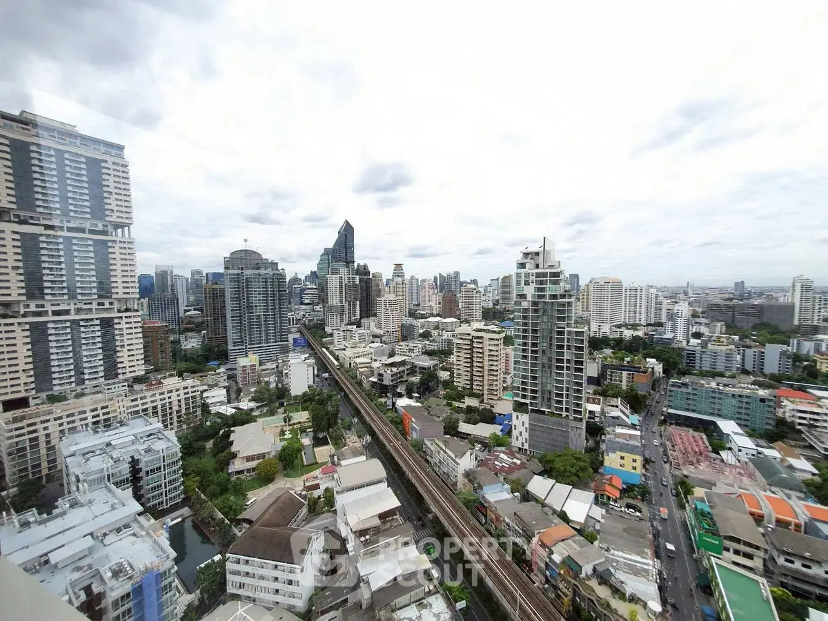 Stunning cityscape view from high-rise apartment showcasing urban skyline and vibrant city life.