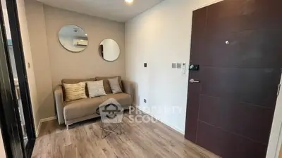 Cozy living room with modern sofa and stylish decor mirrors.