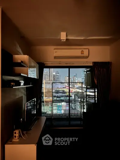 Modern apartment with stunning city view from living room balcony at night.