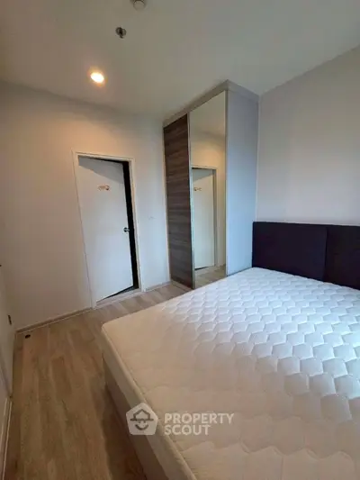 Modern bedroom with sleek wardrobe and comfortable bed in stylish apartment.