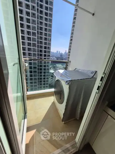 Modern balcony with washing machine and stunning city view in high-rise apartment.