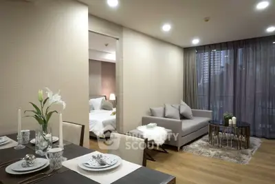Elegant open-plan living room with dining area and cozy bedroom view, featuring modern decor and large windows.