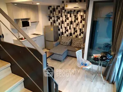 Modern duplex apartment with stylish kitchen and cozy living area, featuring contemporary decor and ample natural light.