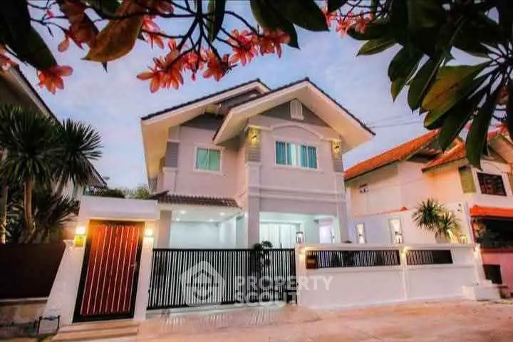 Charming two-story house with modern design and lush landscaping, perfect for family living.