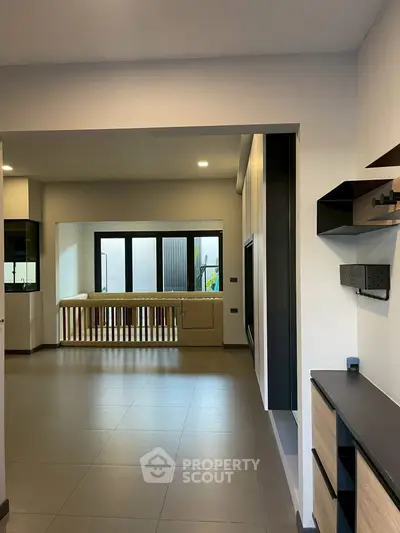 Spacious modern living room with sleek design and large windows