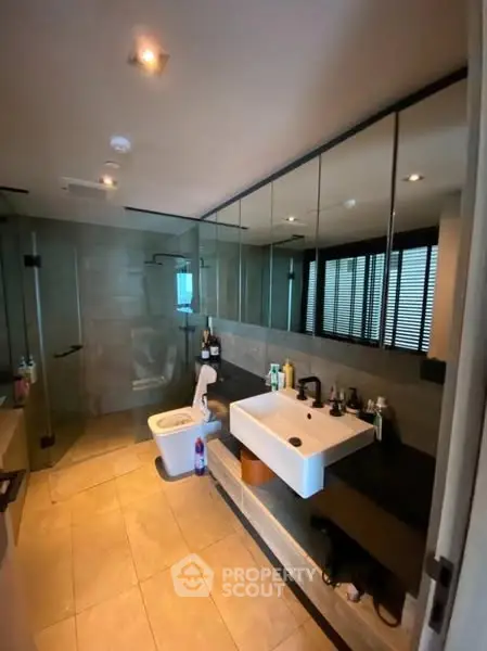 Modern bathroom with sleek design and large mirrors