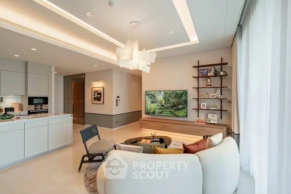 Modern living room with open kitchen, stylish furniture, and elegant lighting