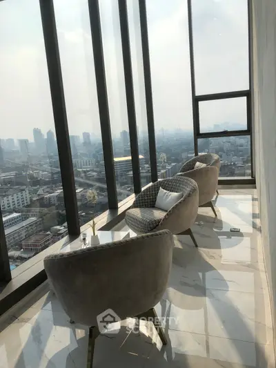 Luxurious high-rise balcony with panoramic city views and elegant seating area.