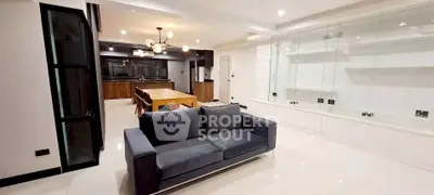 Spacious modern living room with sleek furniture and open kitchen layout
