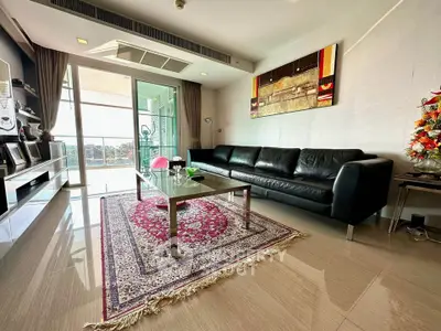 Luxurious living room with modern decor and spacious balcony view