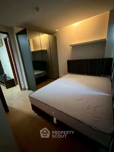Cozy bedroom with modern wardrobe and ambient lighting, perfect for restful nights.