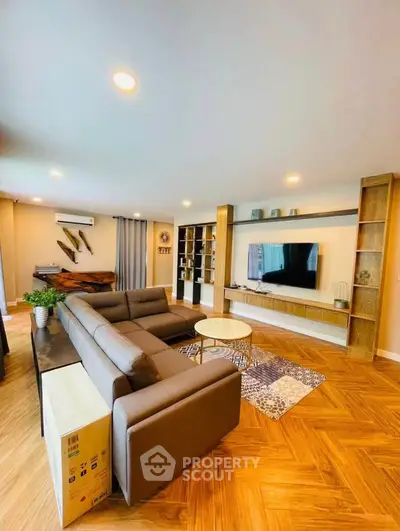 Spacious modern living room with stylish furniture and wooden flooring