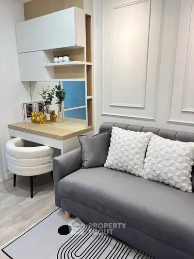 Stylish modern living room with cozy gray sofa and elegant decor
