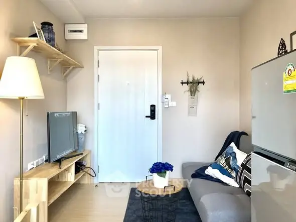 Cozy living room with modern decor and compact furniture arrangement.