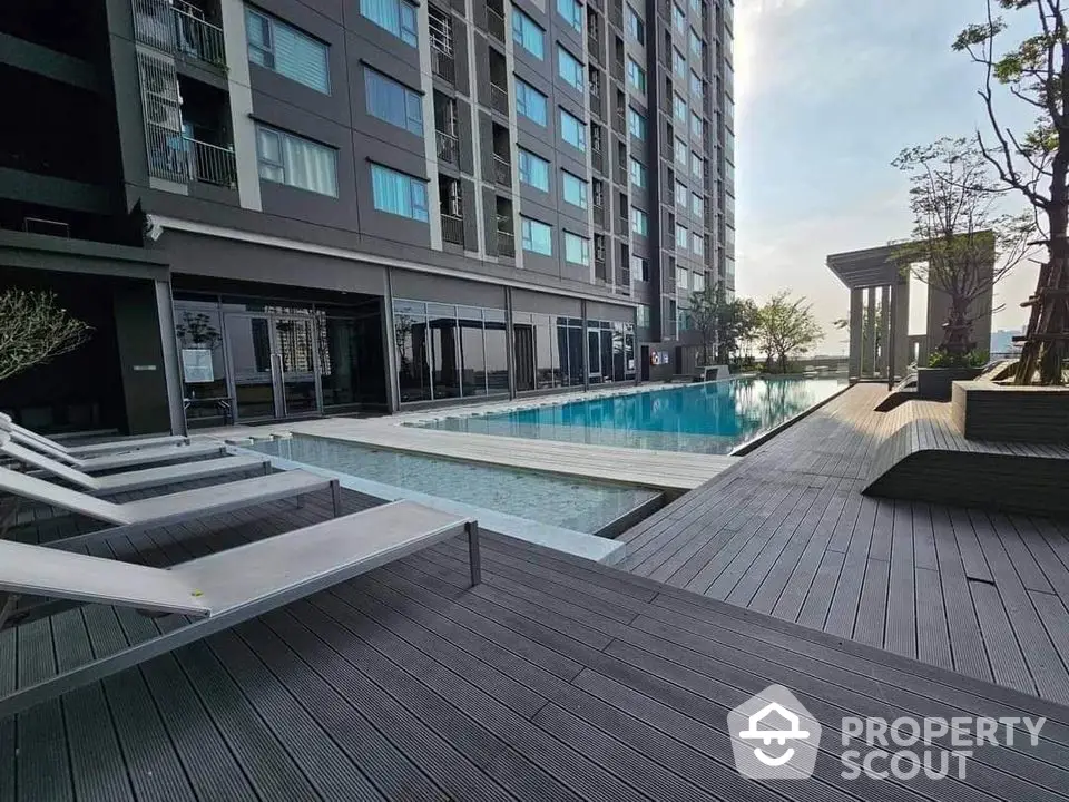 Luxurious high-rise apartment with stunning poolside view and modern amenities.