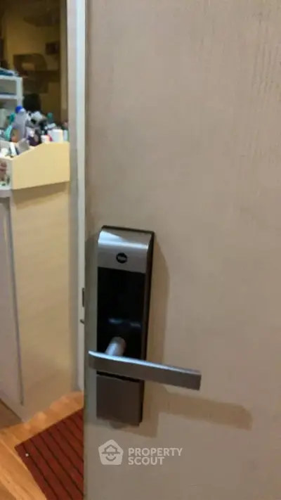 Modern interior door with sleek electronic lock in cozy home setting.