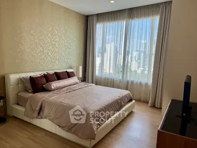 Luxurious bedroom with city view, elegant decor, and natural light in modern apartment.