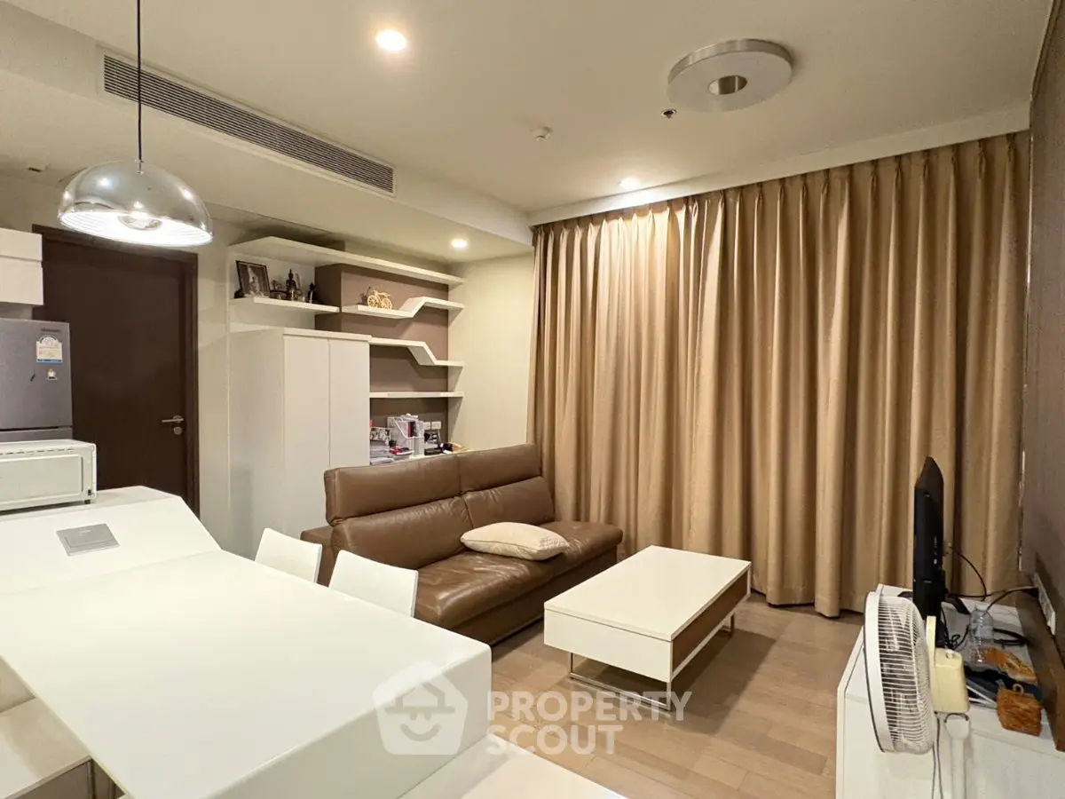 Modern living room with sleek furniture and warm lighting, perfect for cozy evenings.