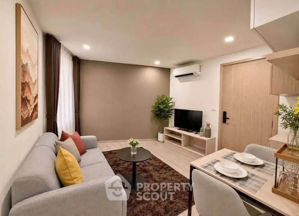 Modern living room with cozy sofa, stylish decor, and dining area in open layout apartment.