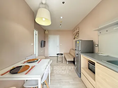 Modern apartment interior with dining area, cozy seating, and sleek kitchen appliances.