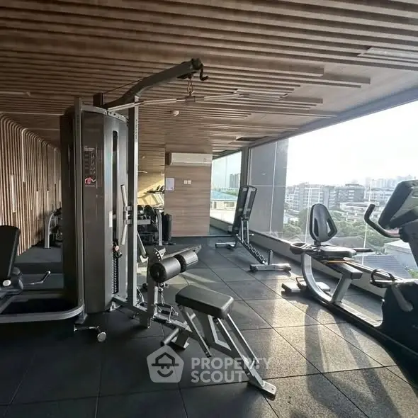 Modern gym with city view and state-of-the-art equipment