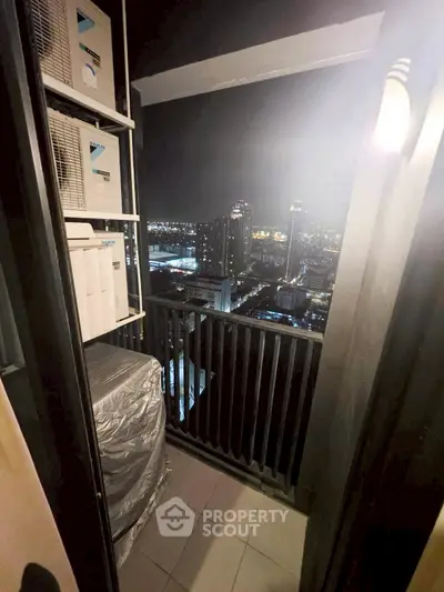 Cozy balcony with stunning city night view, perfect for relaxation and enjoying urban skyline.