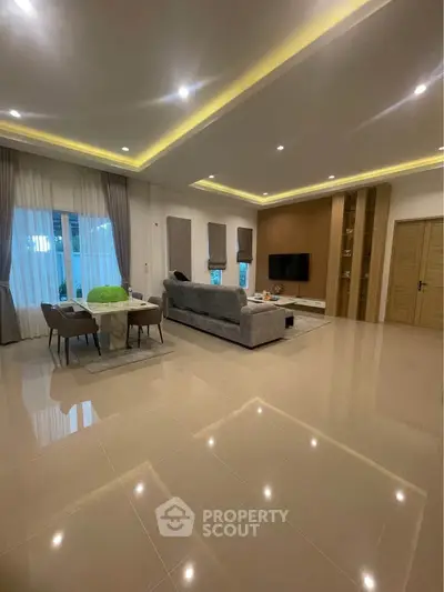 Spacious modern living room with elegant lighting and stylish decor
