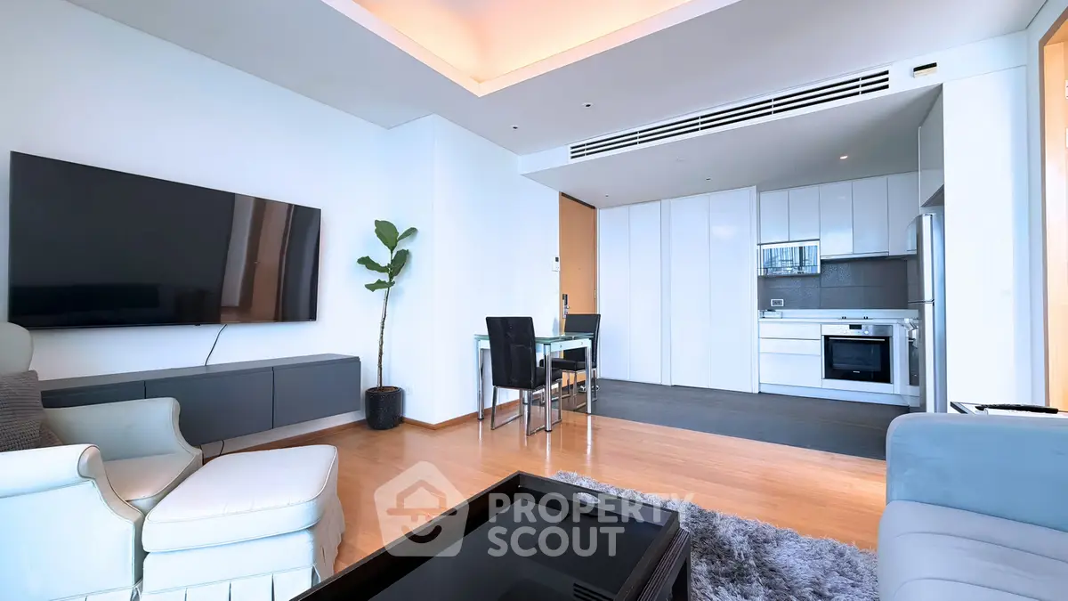 Modern open-layout living room with sleek kitchen and stylish decor