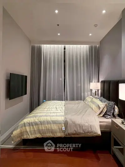 Luxurious bedroom with modern decor and ambient lighting, featuring a cozy bed and elegant curtains.
