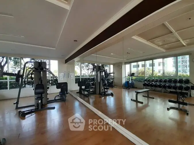 Spacious and well-equipped fitness center in a luxury residential complex with modern machines and a serene environment.