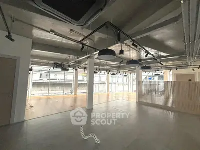 Spacious modern interior with industrial ceiling and large windows