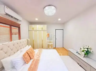 Luxurious bedroom with elegant decor and modern furnishings, featuring a plush bed and stylish wardrobe.