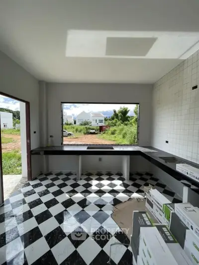 Modern kitchen under construction with checkered floor and open view