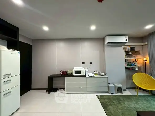 Modern living room with sleek furniture, air conditioning, and a cozy ambiance.