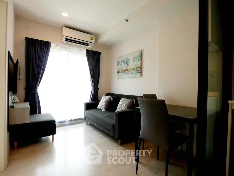 Modern living room with sleek furniture and natural light, perfect for relaxation and entertainment.