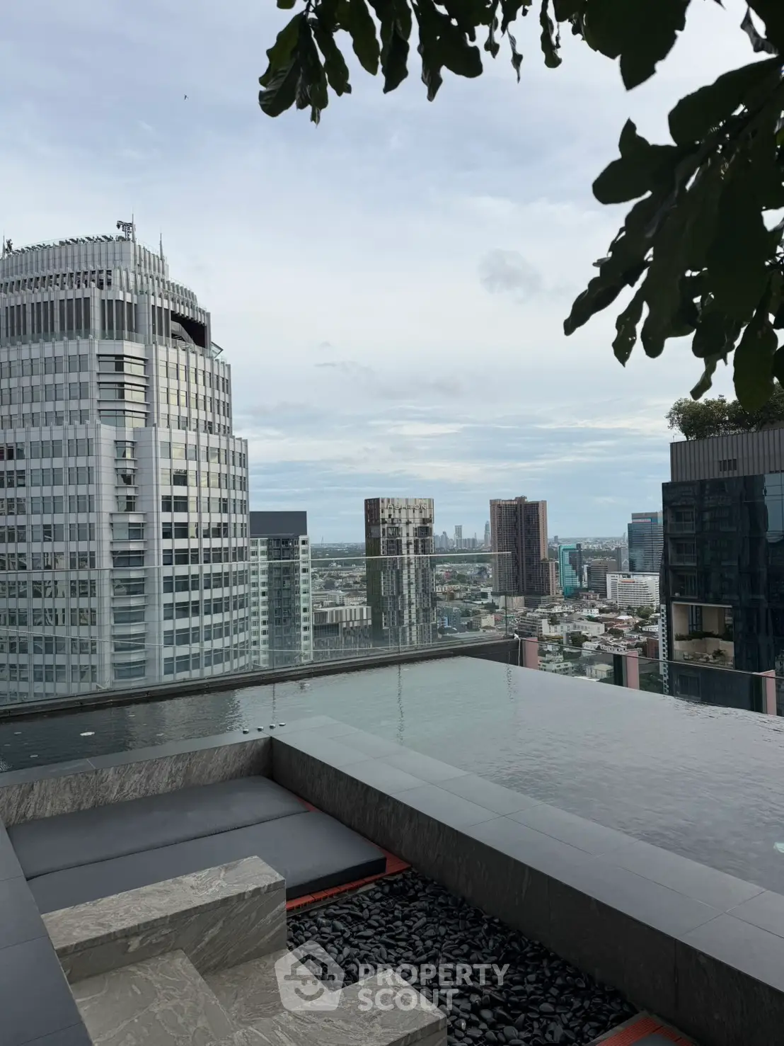 Stunning rooftop pool with panoramic city skyline views, perfect for luxury urban living.
