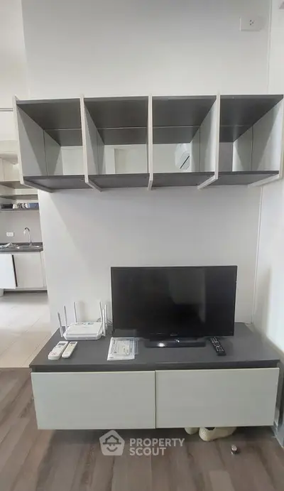 Modern living room with sleek TV stand and wall-mounted shelves