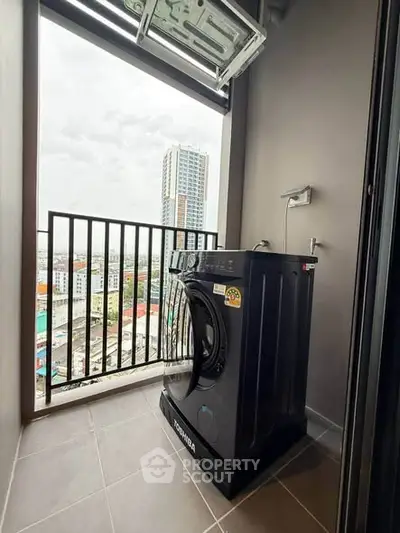 Modern apartment balcony with washing machine and city view, perfect for urban living.