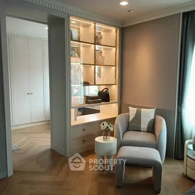 Elegant study nook with modern chair and built-in shelves in a stylish home interior.