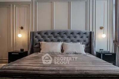 Luxurious bedroom with plush velvet headboard and elegant lighting