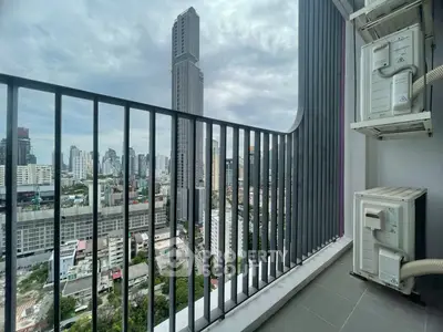Stunning cityscape view from a modern high-rise balcony with sleek railing and urban skyline.